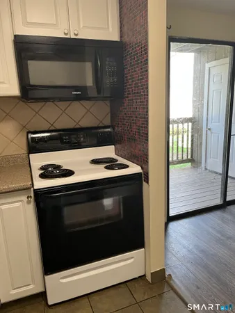 a stove top oven sitting inside of a kitchen