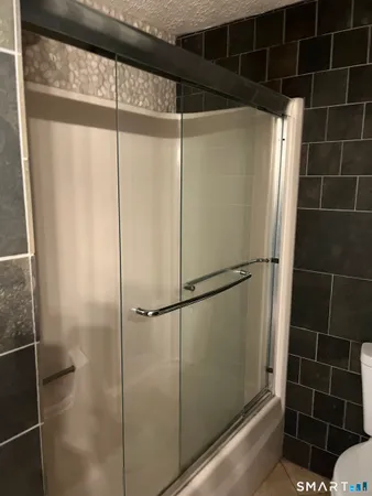 a bathroom with a glass door shower