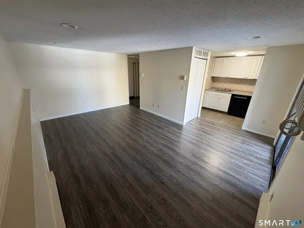 a view of a room with wooden floor and staircase