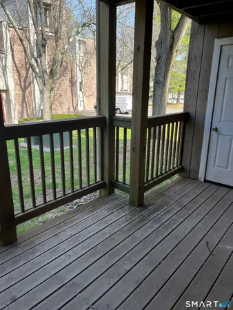 a view of wooden balcony with a swing