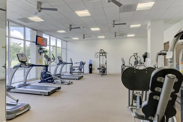 a room with gym equipment and large mirror