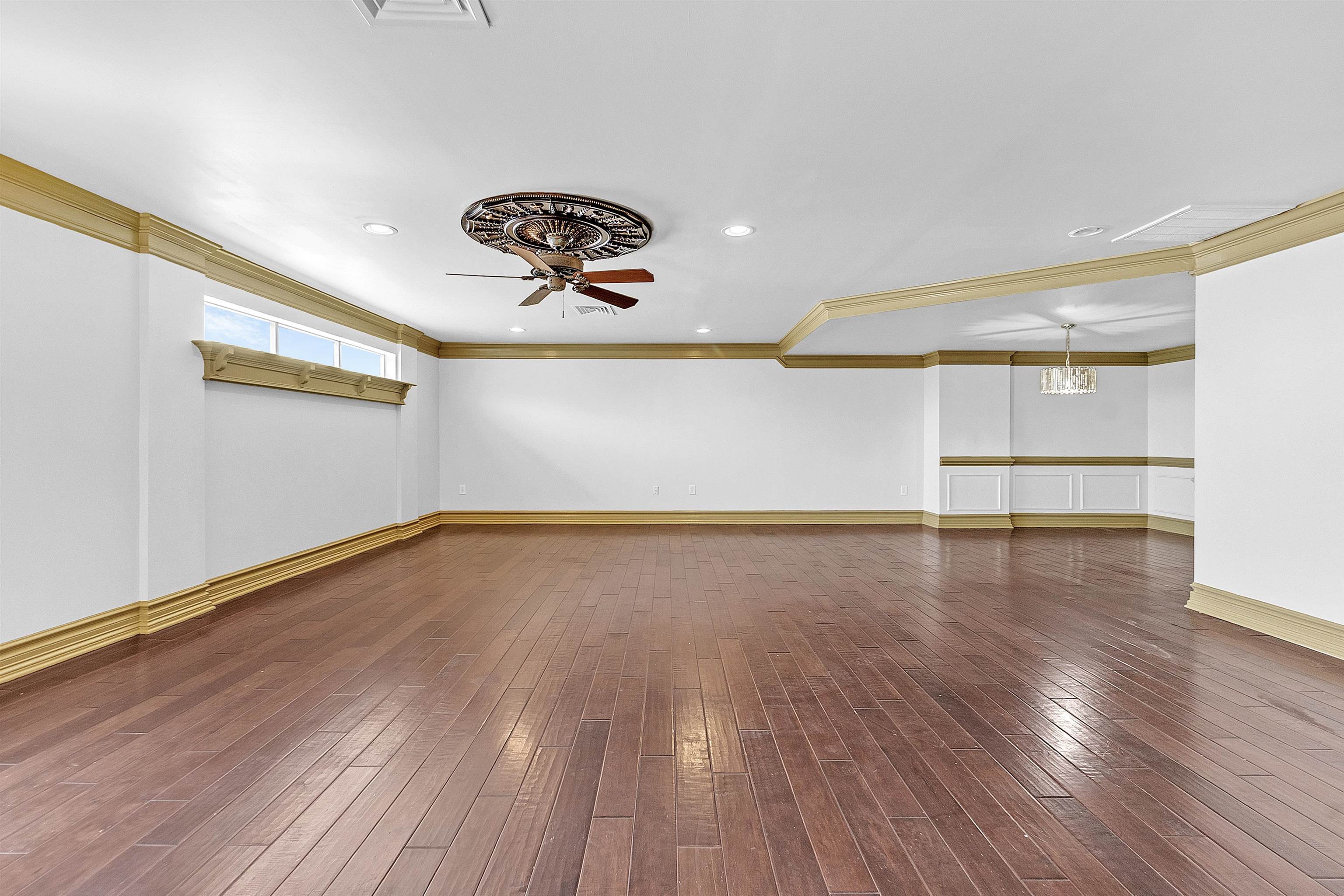 655 Riverside Drive, Unit 206 Memphis, TN 38103 - Photo 11 of 28 a view of an empty room with wooden floor and a window