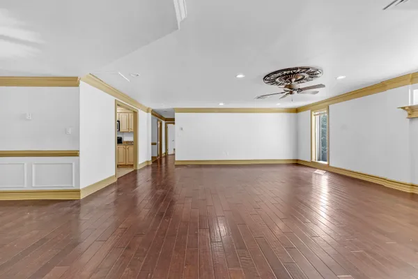 a view of a livingroom with wooden floor and window