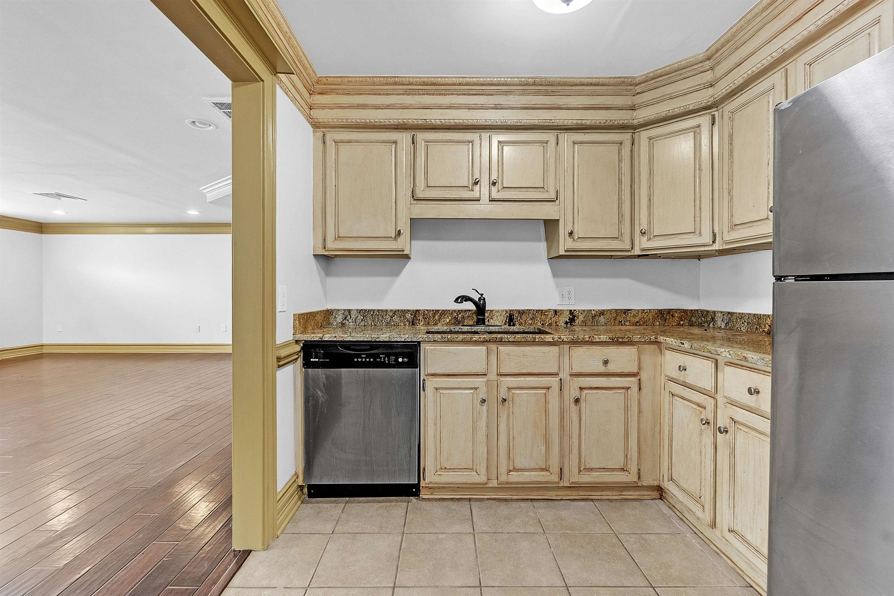 655 Riverside Drive, Unit 206 Memphis, TN 38103 - Photo 13 of 28 a kitchen with stainless steel appliances granite countertop a refrigerator sink and cabinets
