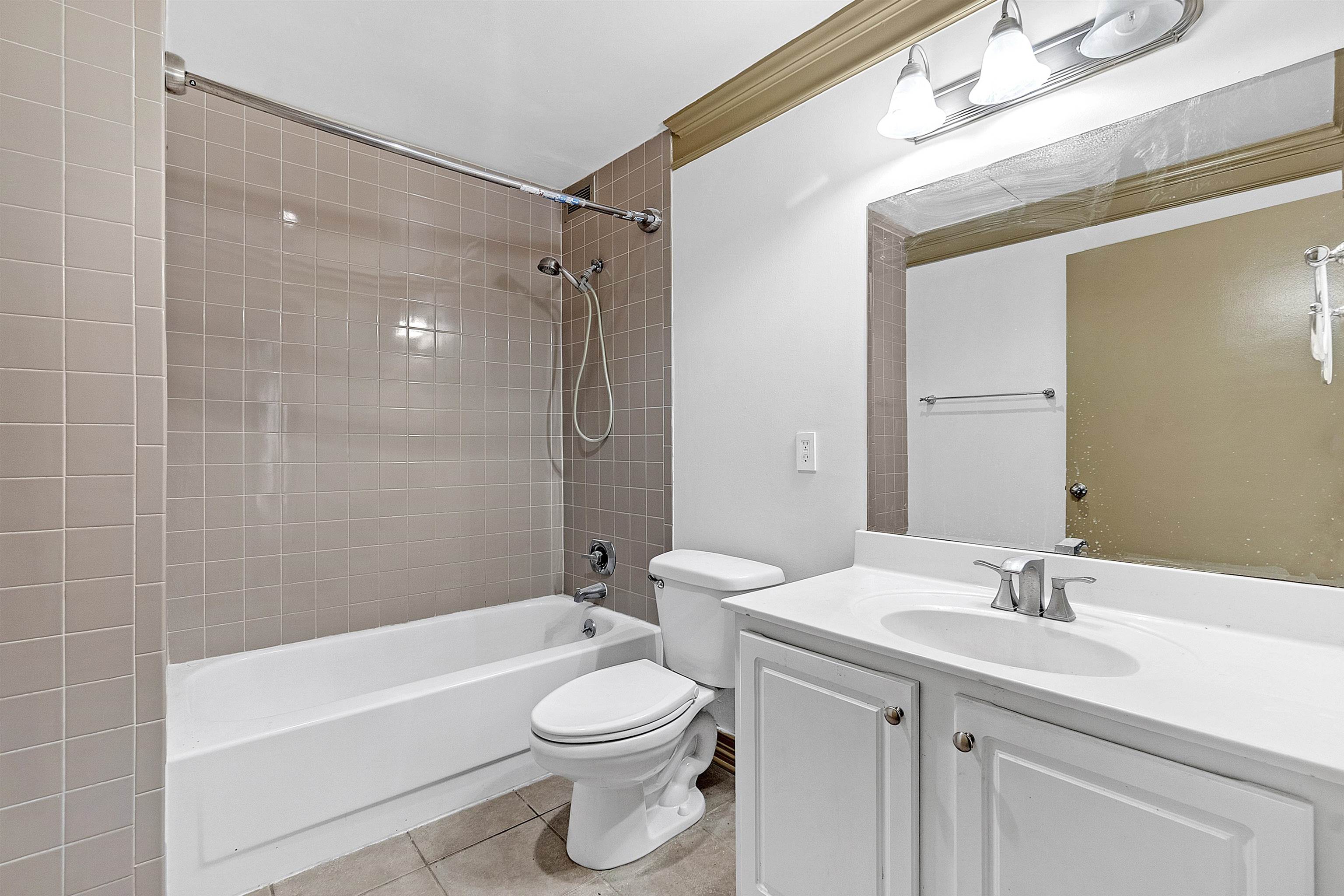655 Riverside Drive, Unit 206 Memphis, TN 38103 - Photo 17 of 28 a bathroom with a sink a toilet and shower