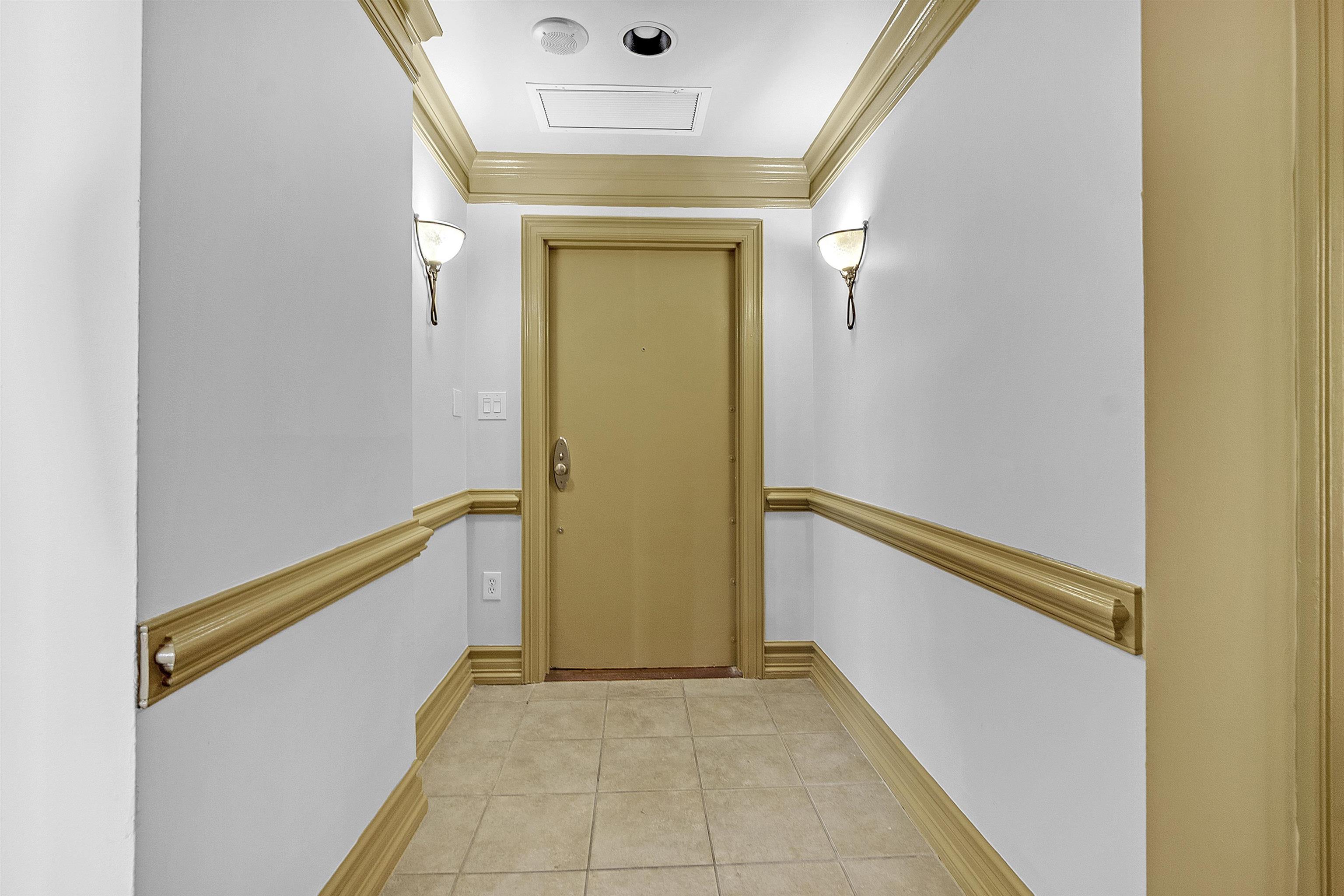 655 Riverside Drive, Unit 206 Memphis, TN 38103 - Photo 18 of 28 a view of a hallway with wooden floor and staircase