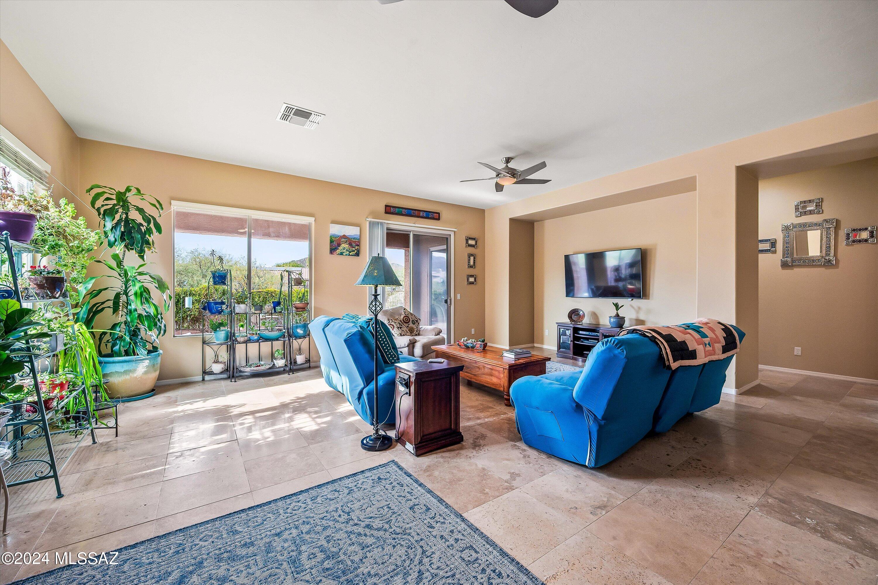 8579 North Shadow Wash Way Tucson, AZ 85743 - Photo 1 of 34 a living room with furniture potted plant and a window