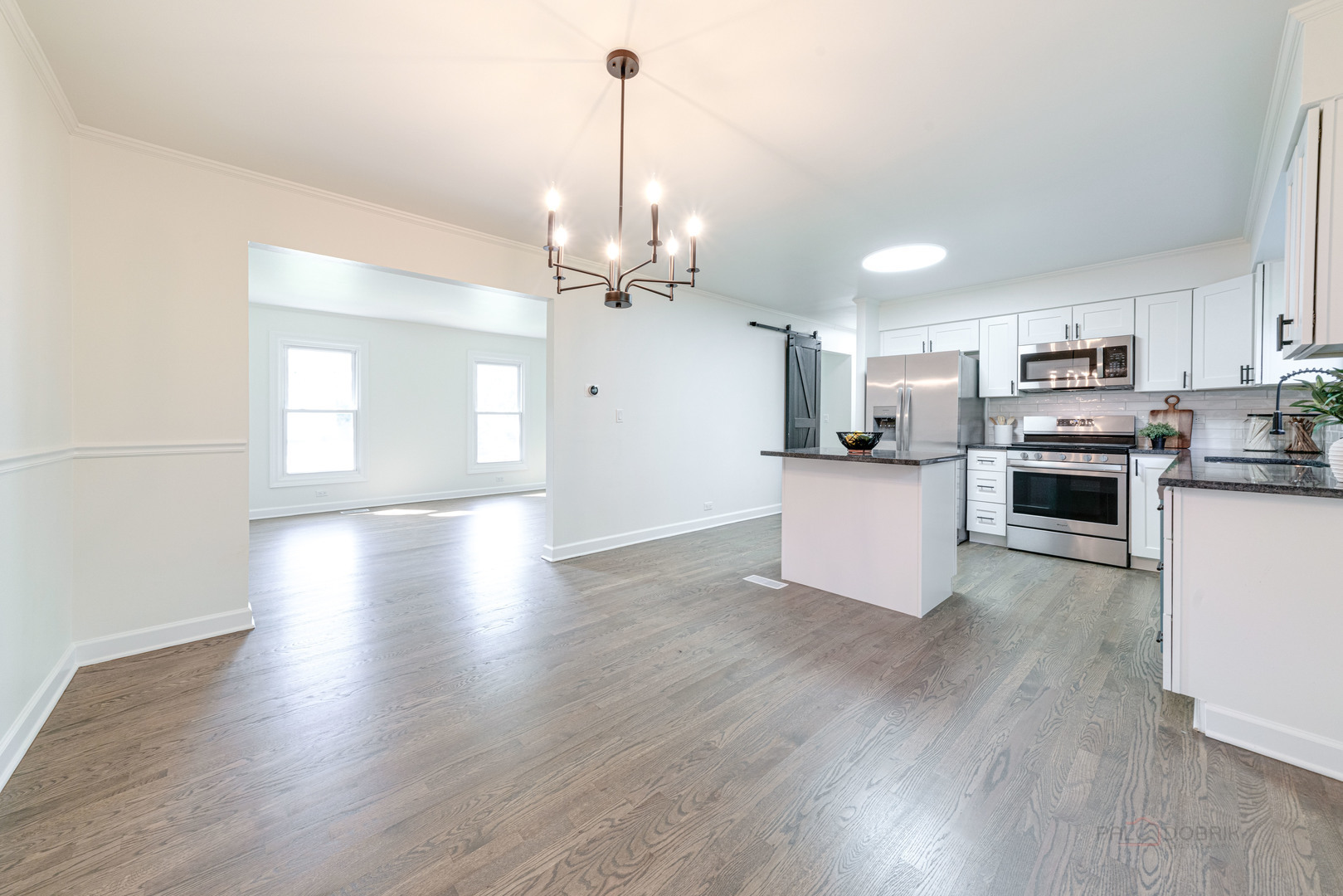 887 Saybrook Lane Buffalo Grove, IL 60089 - Photo 8 of 28 a view of a kitchen with a sink a microwave and wooden floor