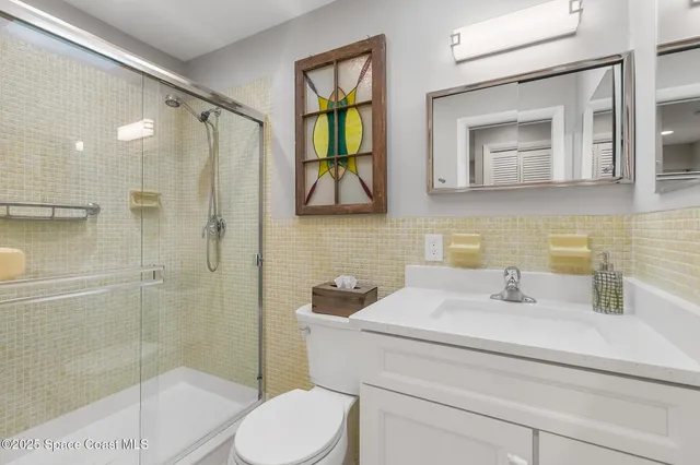 a bathroom with a toilet sink and shower