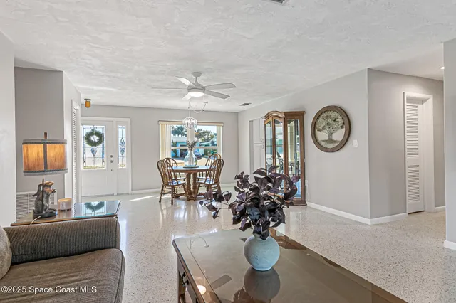 a living room with furniture a clock and a window