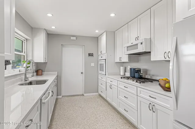 a kitchen with stainless steel appliances granite countertop a sink stove and cabinets
