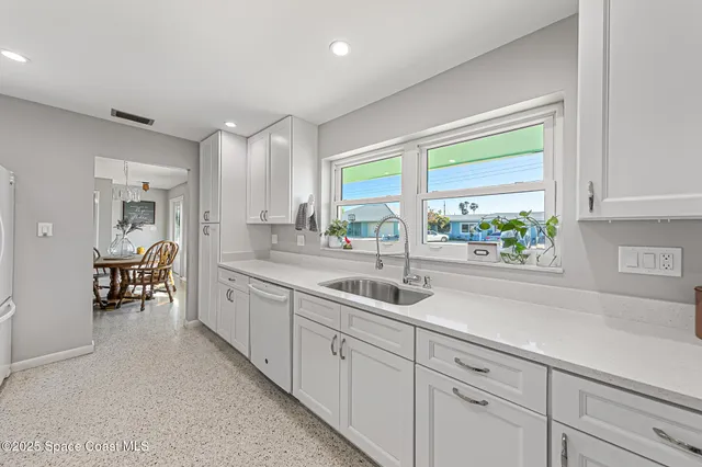 a kitchen with sink and cabinets