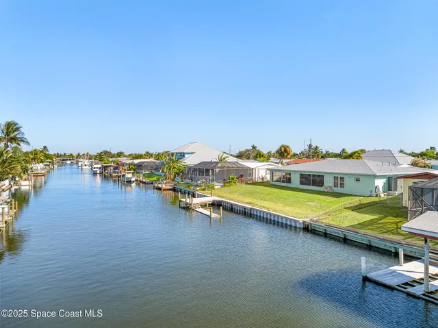 a view of a lake with lawn chairs