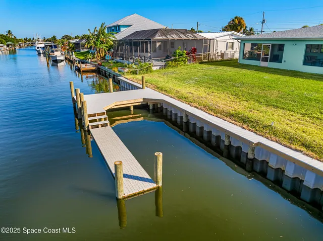 a view of a lake with a table and chairs