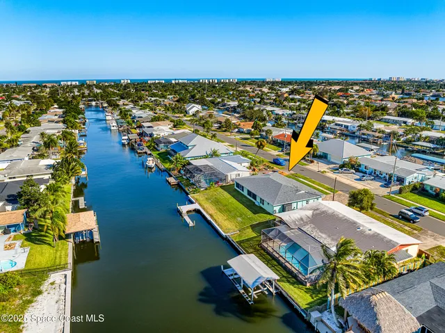 an aerial view of residential houses with outdoor space and swimming pool