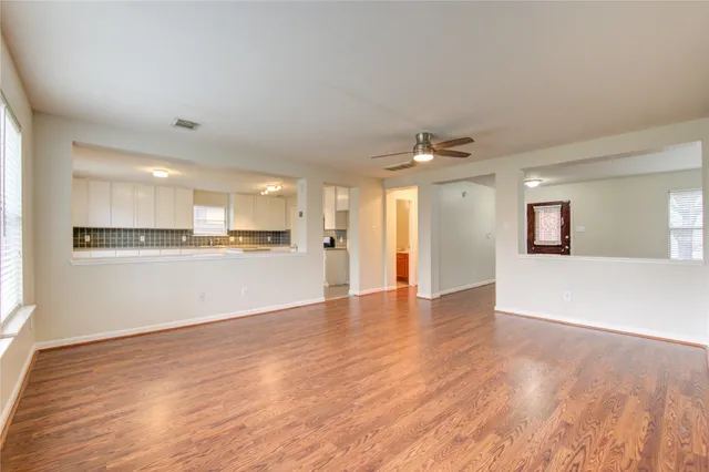 a view of a kitchen with wooden floor and stairs