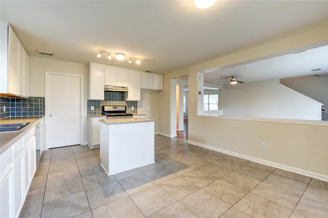 a kitchen that has a sink and a stove