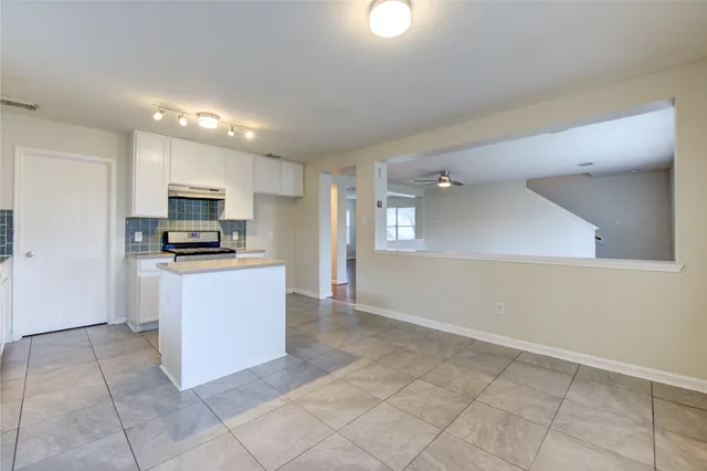 a kitchen with stainless steel appliances granite countertop a stove sink and cabinets