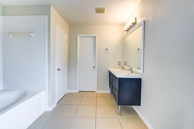 a bathroom with a sink a mirror and a bathtub