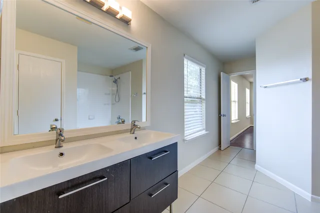 a bathroom with a double vanity sink and a bathtub