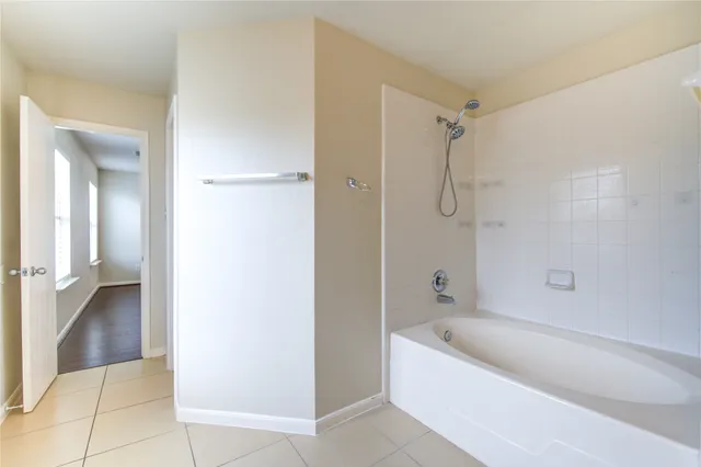 a bathroom with a bathtub and shower