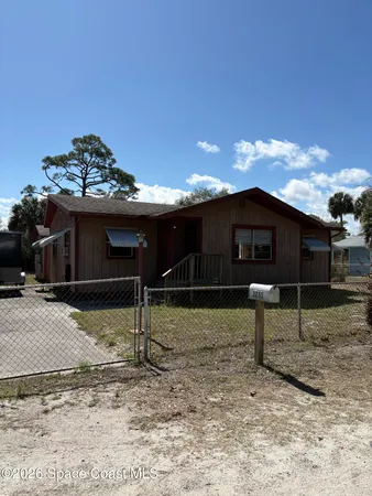 a view of a house with a backyard and a yard