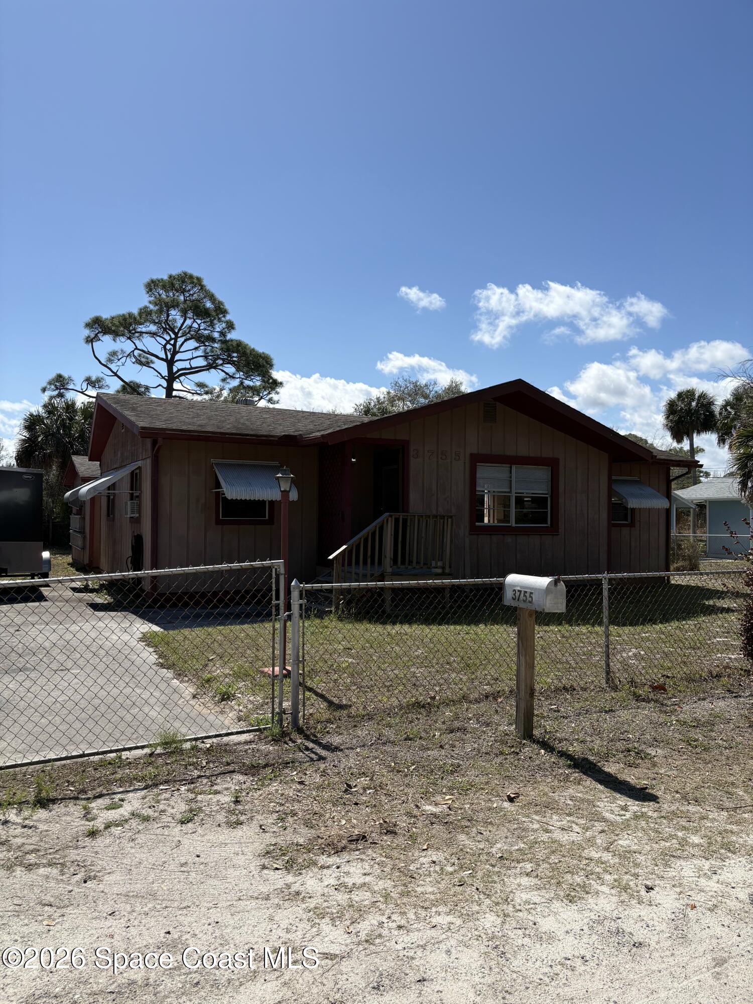 3755 Main Street Sebastian, FL 32976 - Photo 1 of 12 a view of a house with a backyard and a yard