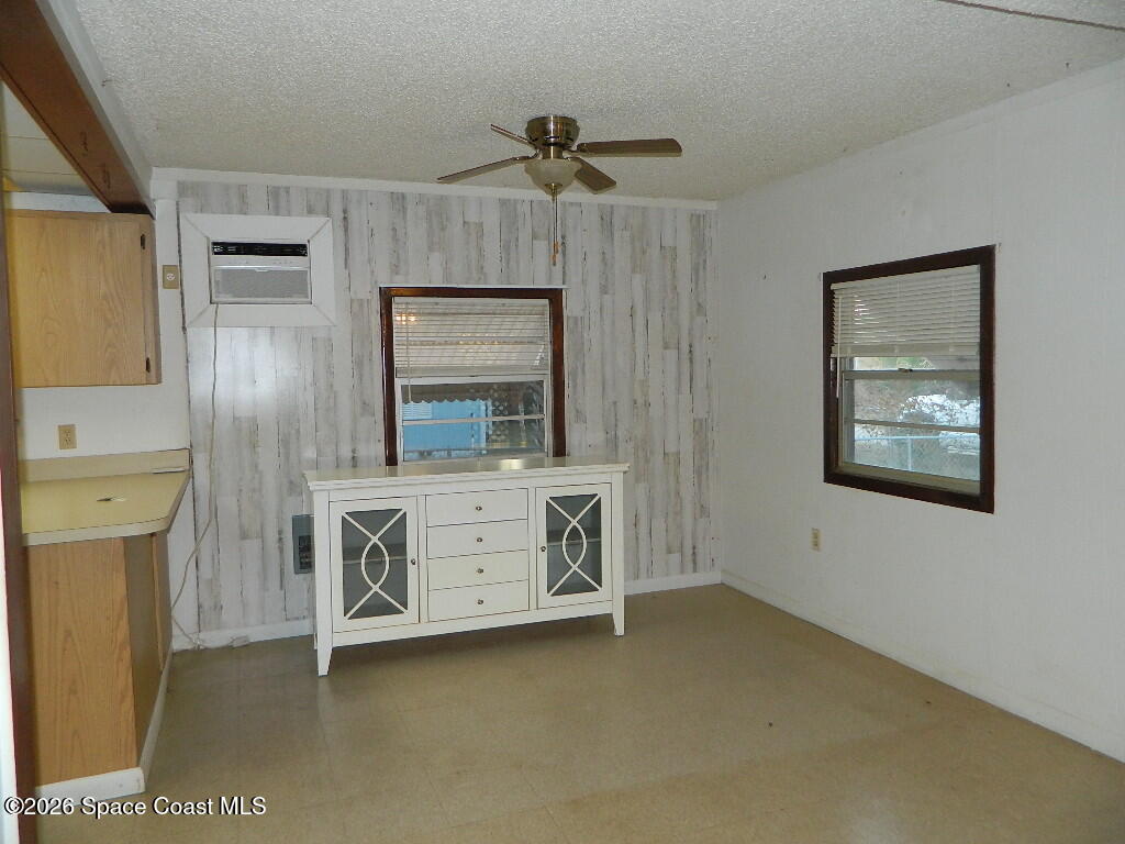 3755 Main Street Sebastian, FL 32976 - Photo 4 of 12 a view of an empty room with a fireplace and a window