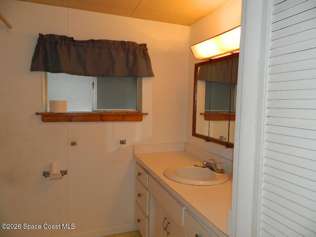 3755 Main Street Sebastian, FL 32976 - Photo 9 of 12 a bathroom with a sink and a mirror