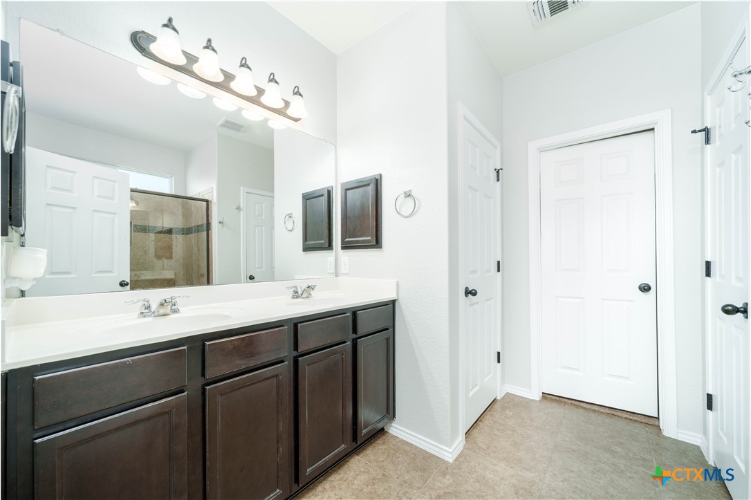 232 Pevero Cibolo, TX 78108 - Photo 12 of 42 a bathroom with a double vanity sink and mirror