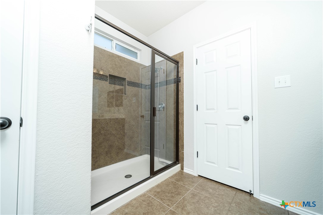 232 Pevero Cibolo, TX 78108 - Photo 13 of 42 a bathroom with a glass shower door