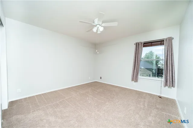 a living room with furniture and a ceiling fan