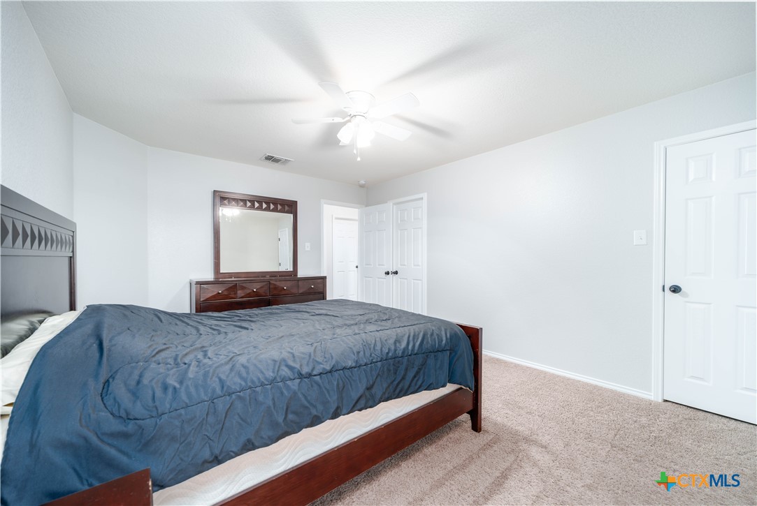 232 Pevero Cibolo, TX 78108 - Photo 19 of 42 a bedroom with a large bed and a chandelier
