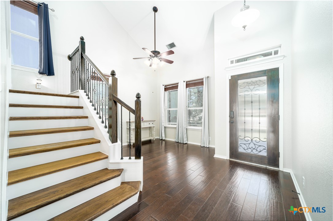 232 Pevero Cibolo, TX 78108 - Photo 3 of 42 a view of a hallway with wooden floor and stairs