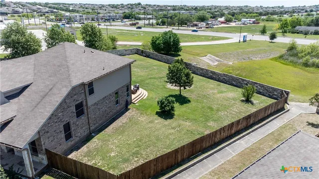 an aerial view of house with yard