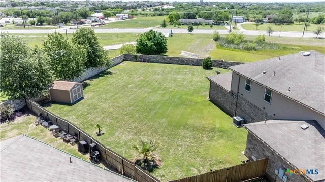 an aerial view of a house with a lake view