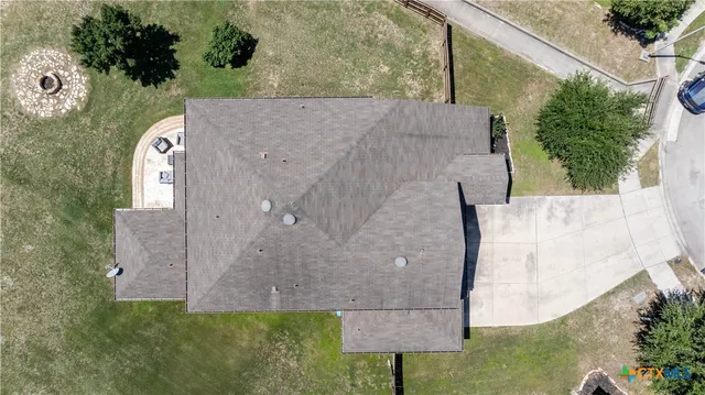 an aerial view of a house with a yard