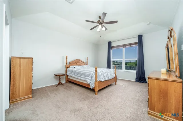 a bathroom with a granite countertop sink a toilet and a mirror