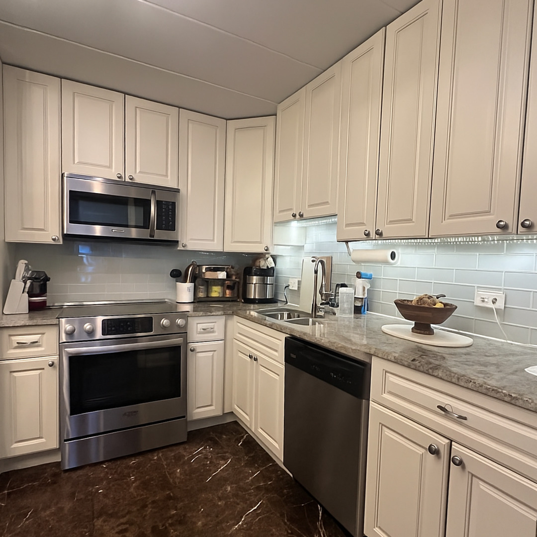905 Center Street, Unit 208 Des Plaines, IL 60016 - Photo 2 of 24 a kitchen with stainless steel appliances granite countertop a sink a stove and a microwave