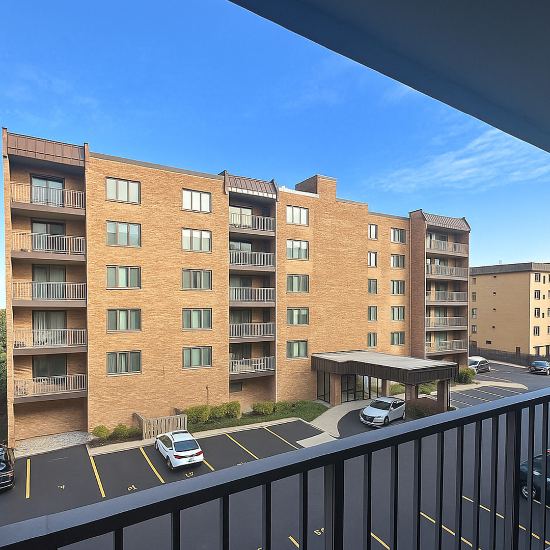 905 Center Street, Unit 208 Des Plaines, IL 60016 - Photo 21 of 24 a view of a large building from a balcony