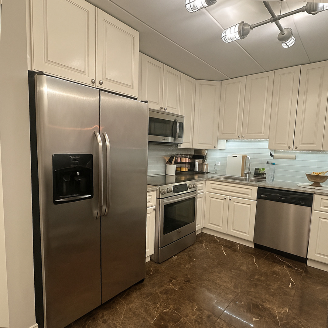 905 Center Street, Unit 208 Des Plaines, IL 60016 - Photo 3 of 24 a kitchen with stainless steel appliances granite countertop a refrigerator a stove a sink and white cabinets