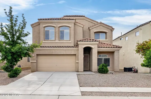 a front view of a house with garage