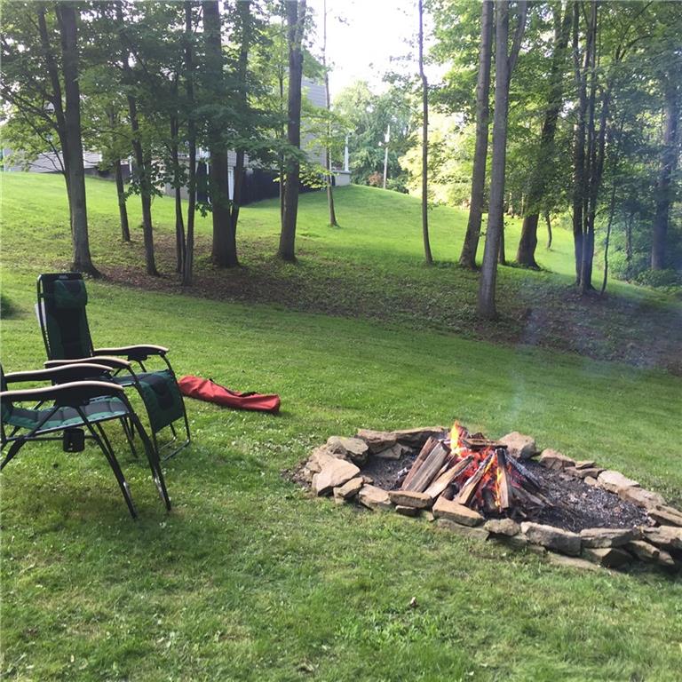 486 Moores Grove Road New Stanton, PA 15672 - Photo 5 of 25 OVER AN ACRE WOODED AND PRIVATE LOT WITH FIRE PIT.