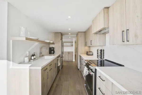 a kitchen with a sink a stove and cabinets