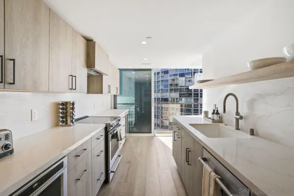a kitchen with stainless steel appliances a sink stove and cabinets