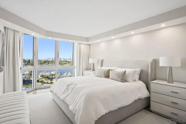 a bedroom with a large bed and a large window