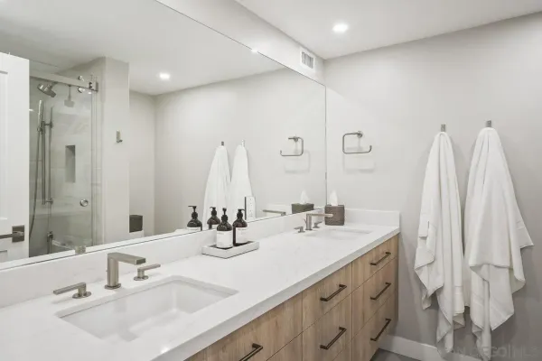 a bathroom with double vanity sink and a mirror