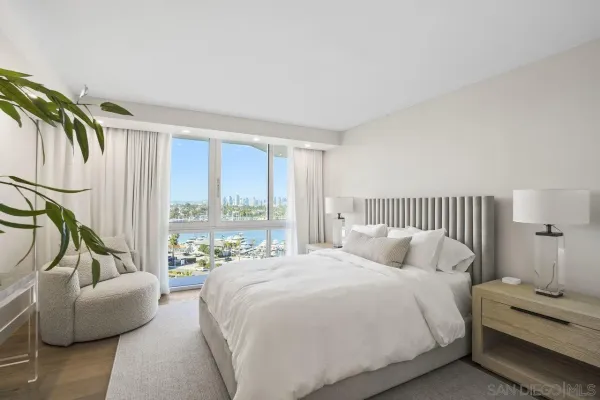 a bedroom with a bed and a couch next to a window