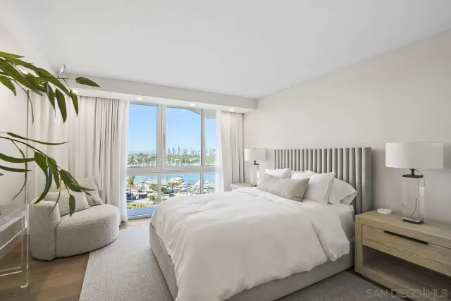 a bedroom with a bed and a couch next to a window