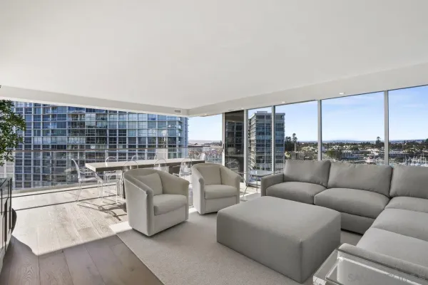 a living room with furniture and a floor to ceiling window